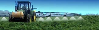 A tractor spraying pesticides to crops on a farm