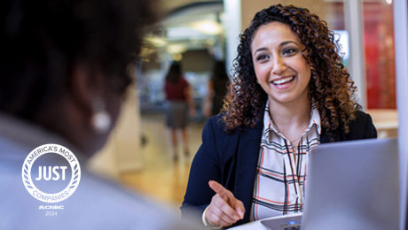 Employee smiling with JUST logo