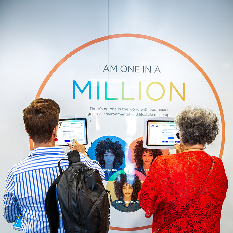 Two people filling out information on tablets