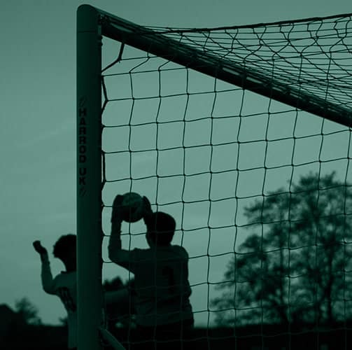 soccer players playing in front of goal