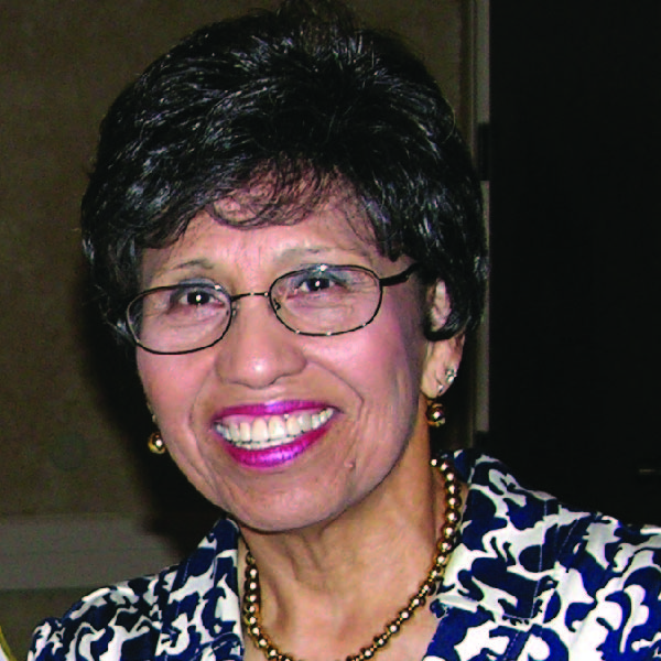 Head shot of Linda Chavez-Thompson. She wears glasses and is smiling directly at the camera.