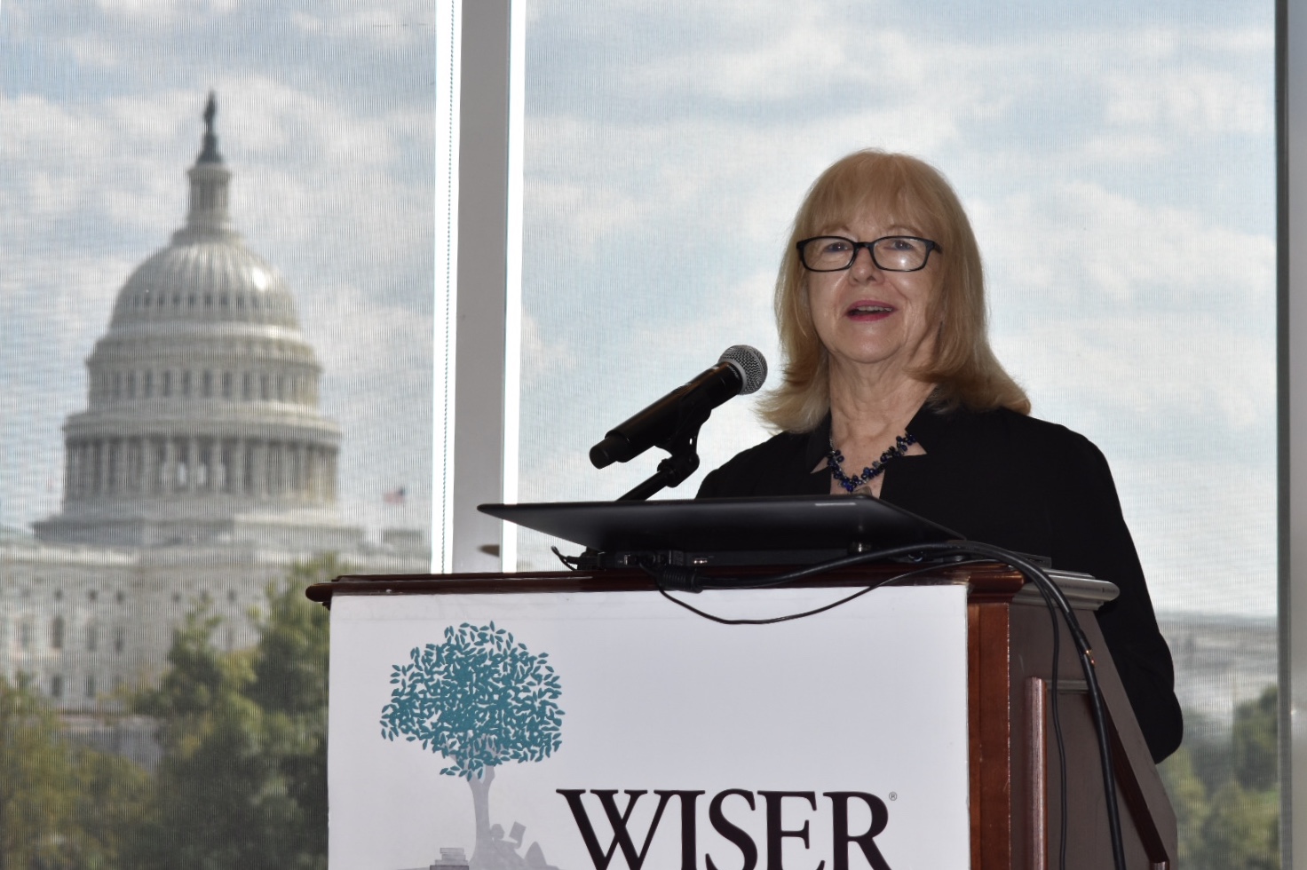 Cindy Hounsell standing at a WISER podium