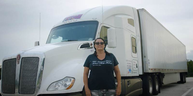 Desiree Wood in front of a truck. 