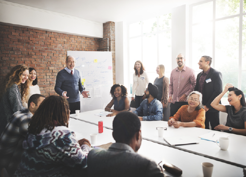 Group of workers smiling at a conference table