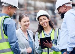 A diverse collection of construction workers on a worksite.