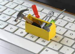 Tiny toolbox sitting on top of a computer keyboard