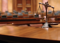 Scales of justice on a desk in a courtroom