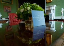 Cancer Moonshot logo on a light blue card on a brown table at the White House