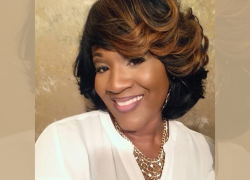 Headshot of a Black woman smiling at the camera