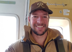 Ben Elkind in an airplane ready to jump out to battle wildland fires