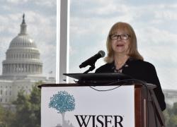 Cindy Hounsell standing at a WISER podium