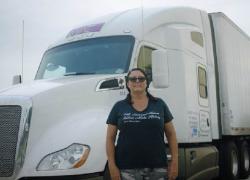 Desiree Wood in front of a truck.