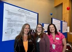 Three union and management employees presenting display boards at the SHARE and UMass Memorial UBT Fair in Worcester, Massachusetts. 