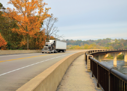 A semi truck drives on a road in rural West Virginia.