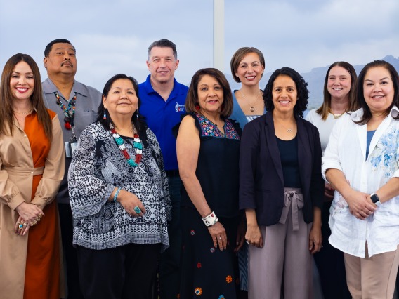 The Community Advisory Board takes a photo in a board room at the University of Arizona Cancer Center.