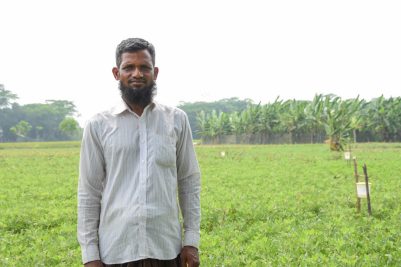 A man standing in a lush green field