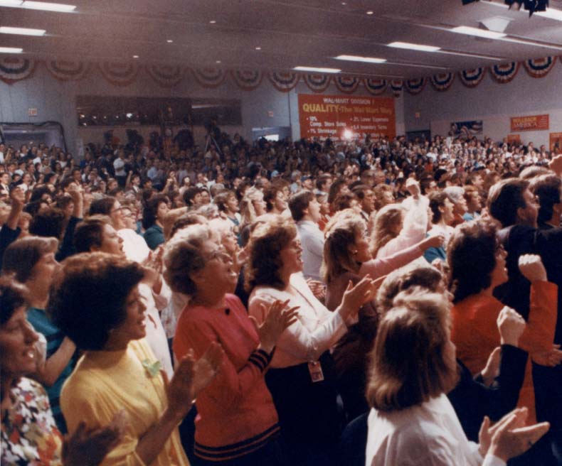 A group of associates cheer as Walmart goes international