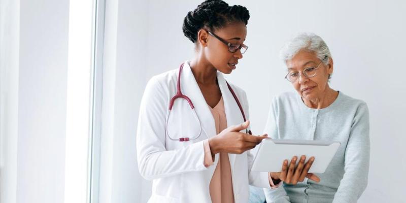 African American doctor talking to senior patient