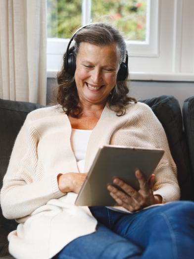 happy-senior-caucasian-woman-in-living-room