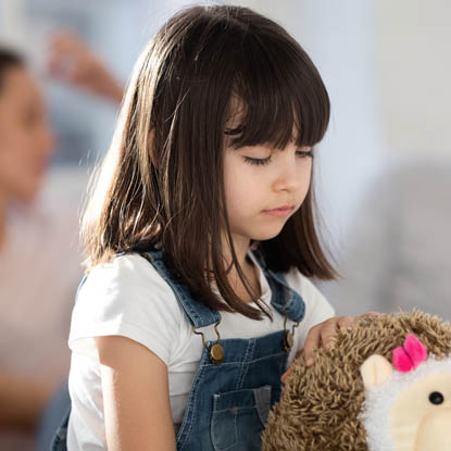 A young girl holding a toy