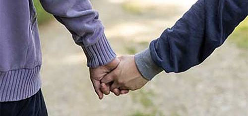 Two people holding hands