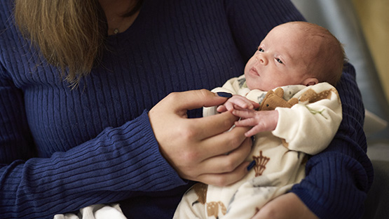 AHN Saint Vincent Hospital maternity patient holder her newborn baby