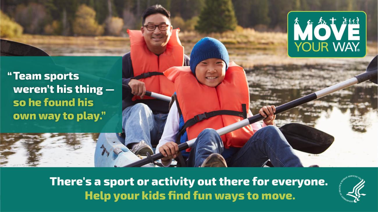 A father and son sit in a canoe in a river in a wooded area wearing bright orange life vests and holding oars on their laps