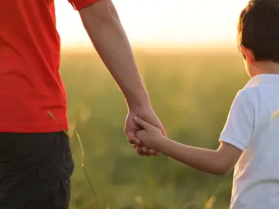 Parent holding child's hand