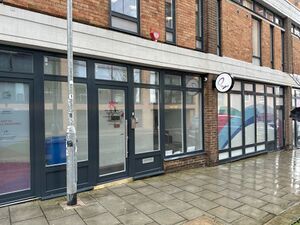 The glass entrance door to The Skiff. Beside it is a lamp post.