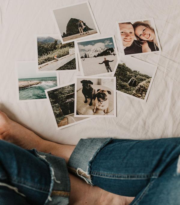 photos spread out on bedspread