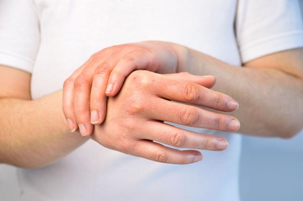 person massaging his hands