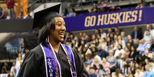 A graduate walks toward the stage