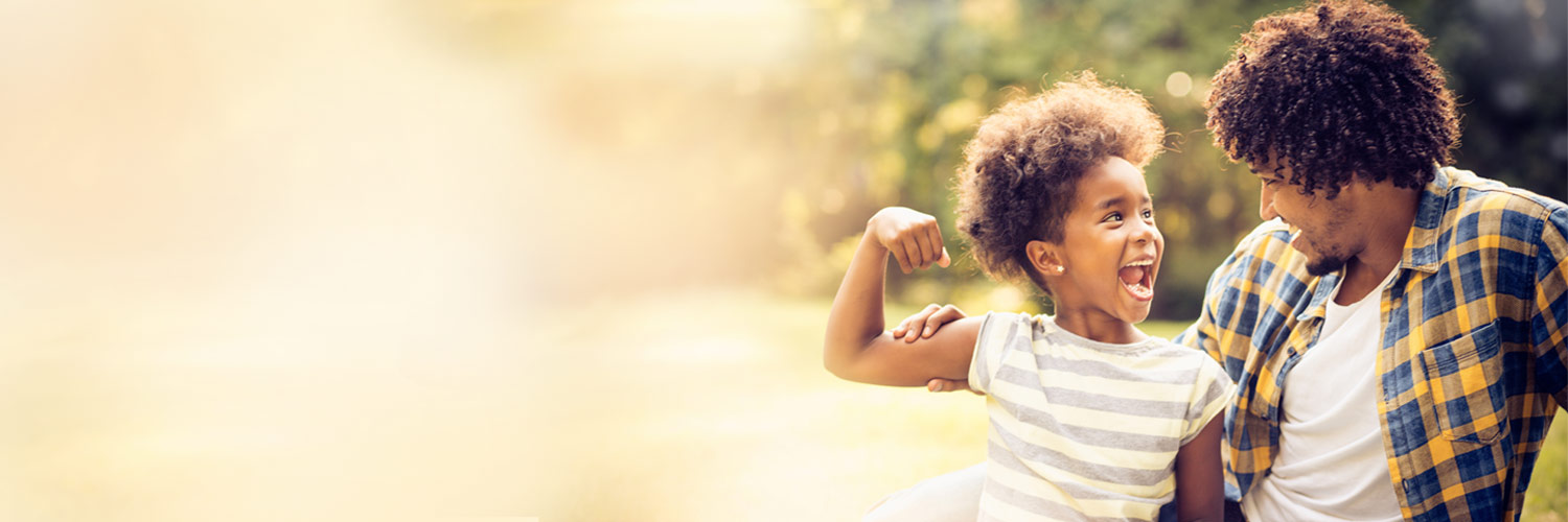 Young girl flexes a muscle to show Dad her strength and confidence.