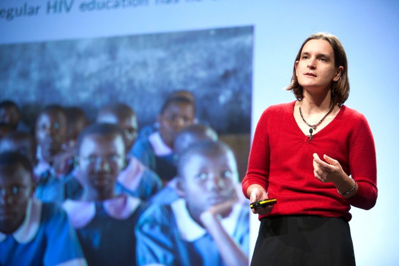 Esther Duflo delivers a presentation on a stage