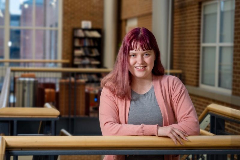 Millie Yopp stands in the Shanks Hall atrium, where her journey as an English major began. Photo by Leslie King for Virginia Tech.