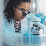 Female scientist looking through a microscope