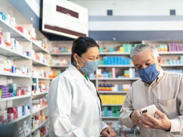 Pharmacist talking with a customer about medications.