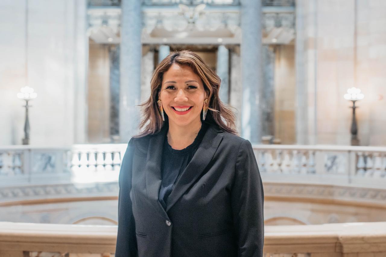 Cindi is in the Minnesota State Capitol, wearing a business jacket. 