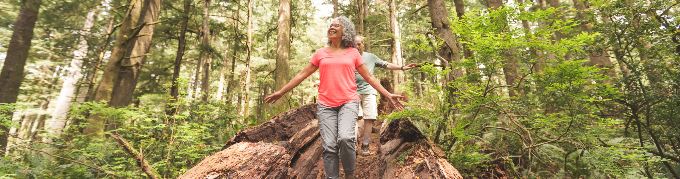 A couple hiking together through a forrest.