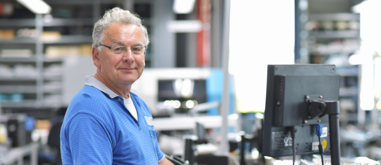 Man smiling while at work.