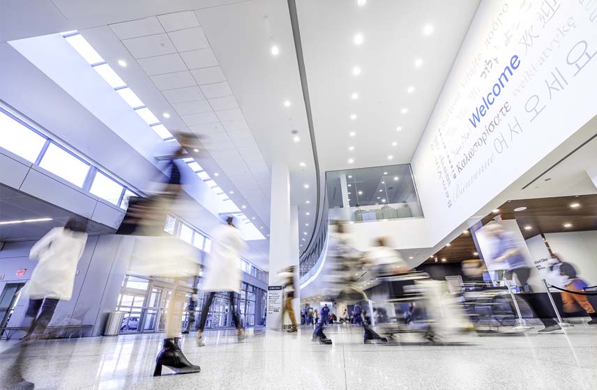 patients and doctors walking under Cleveland Clinic welcome signage