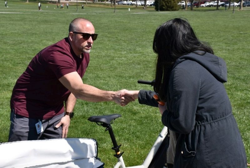 Jon Dance on the drillfield next to his Flow Zone bike, talking to a visitor. Photo courtesy of Jon Dance.