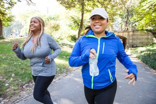 Two young women exercising outdoors.