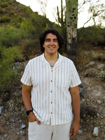 William Carson smiles in a portrait taken in the Sonoran Desert near sunset.