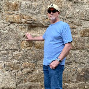 Dave Bullock Stands in Front of a Castle in France