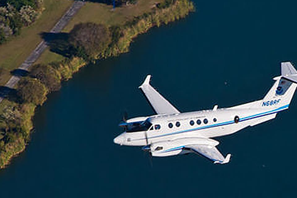 An airplane flying over a coastal area