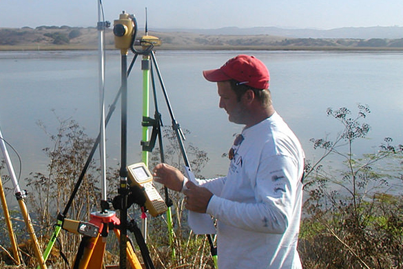 A geodesist using measuring equipment