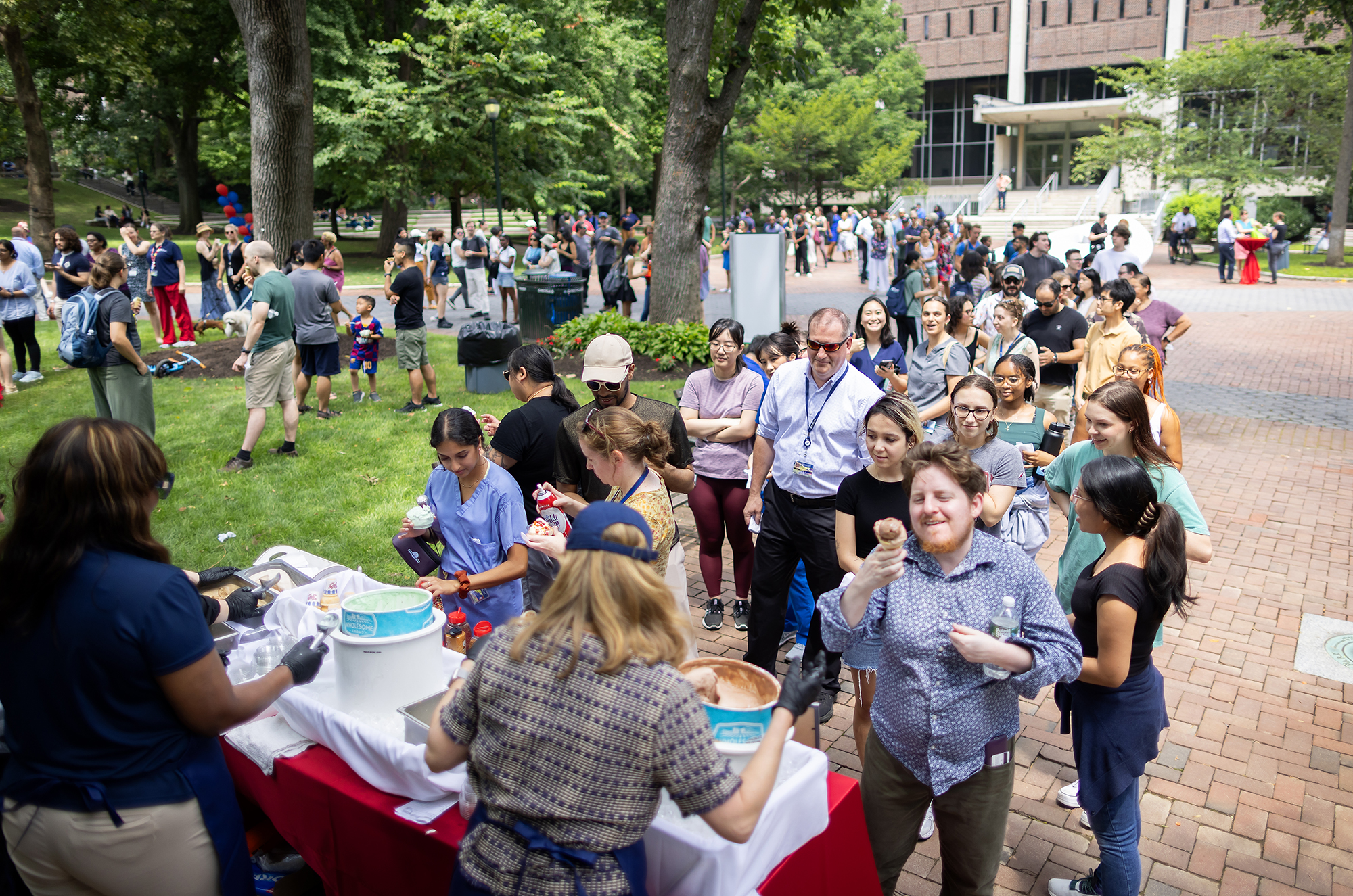 A crowd gathers on College Green in line for ice cream from Liz Magill.