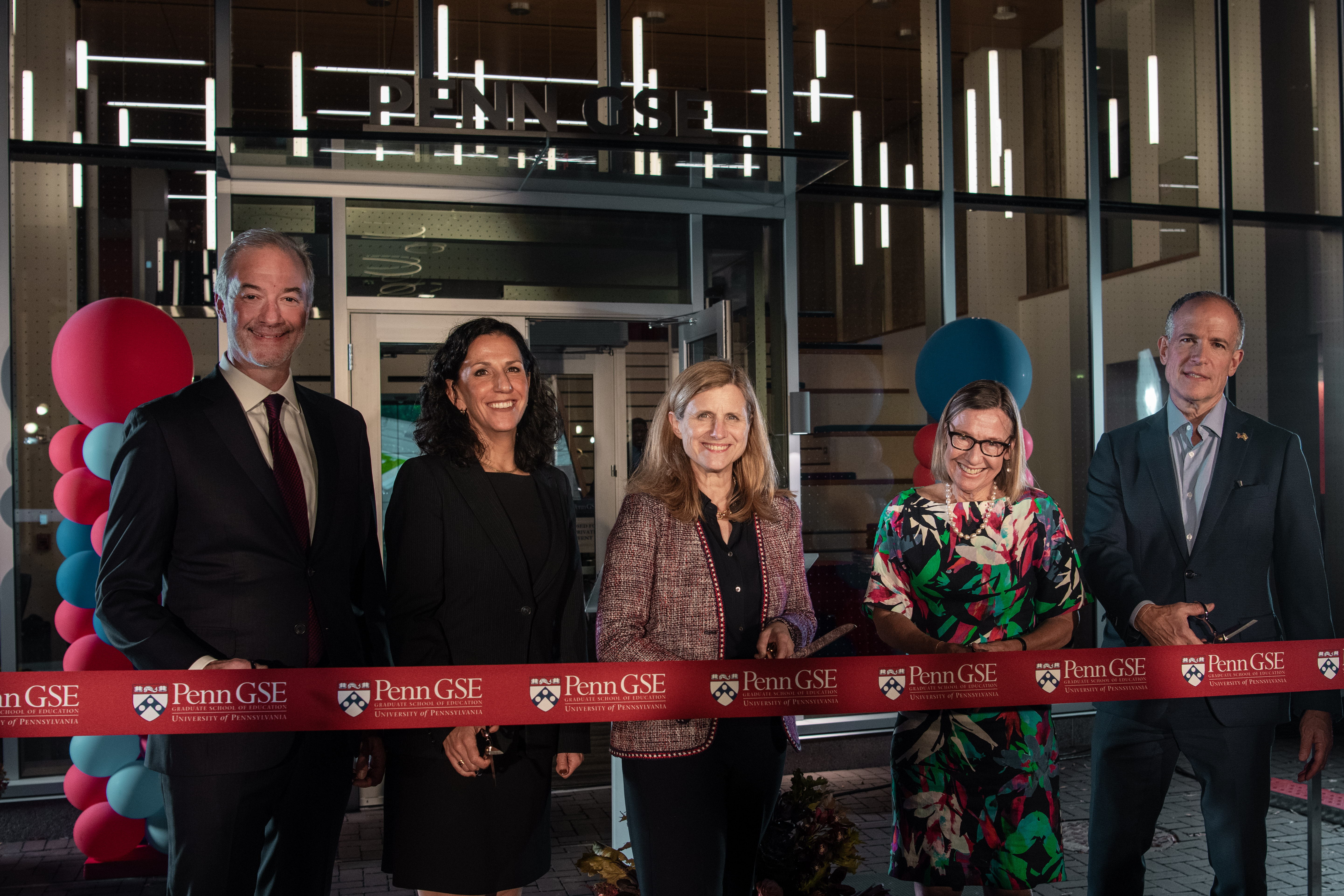 Liz Magill, Pam Grossman, and two others cut the ribbon on the new Penn GSE building.