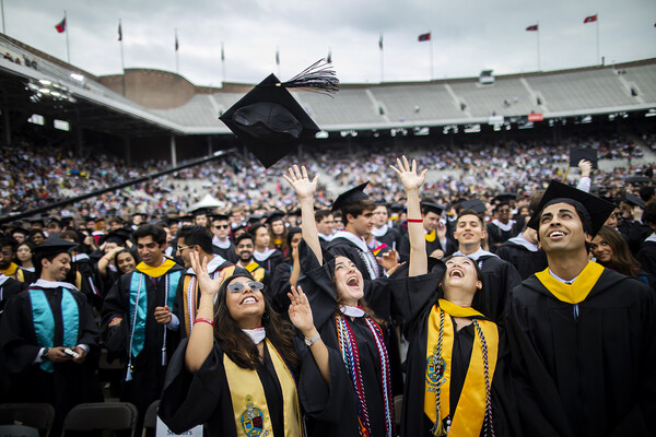 The graduating class of 2022 throwing their caps in the air.